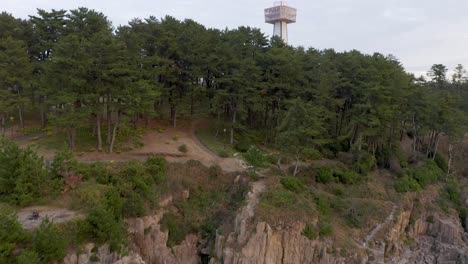 Aerial-tilt-reveal-over-Tojinbo-Coastline,-Fukui-Prefecture-Japan