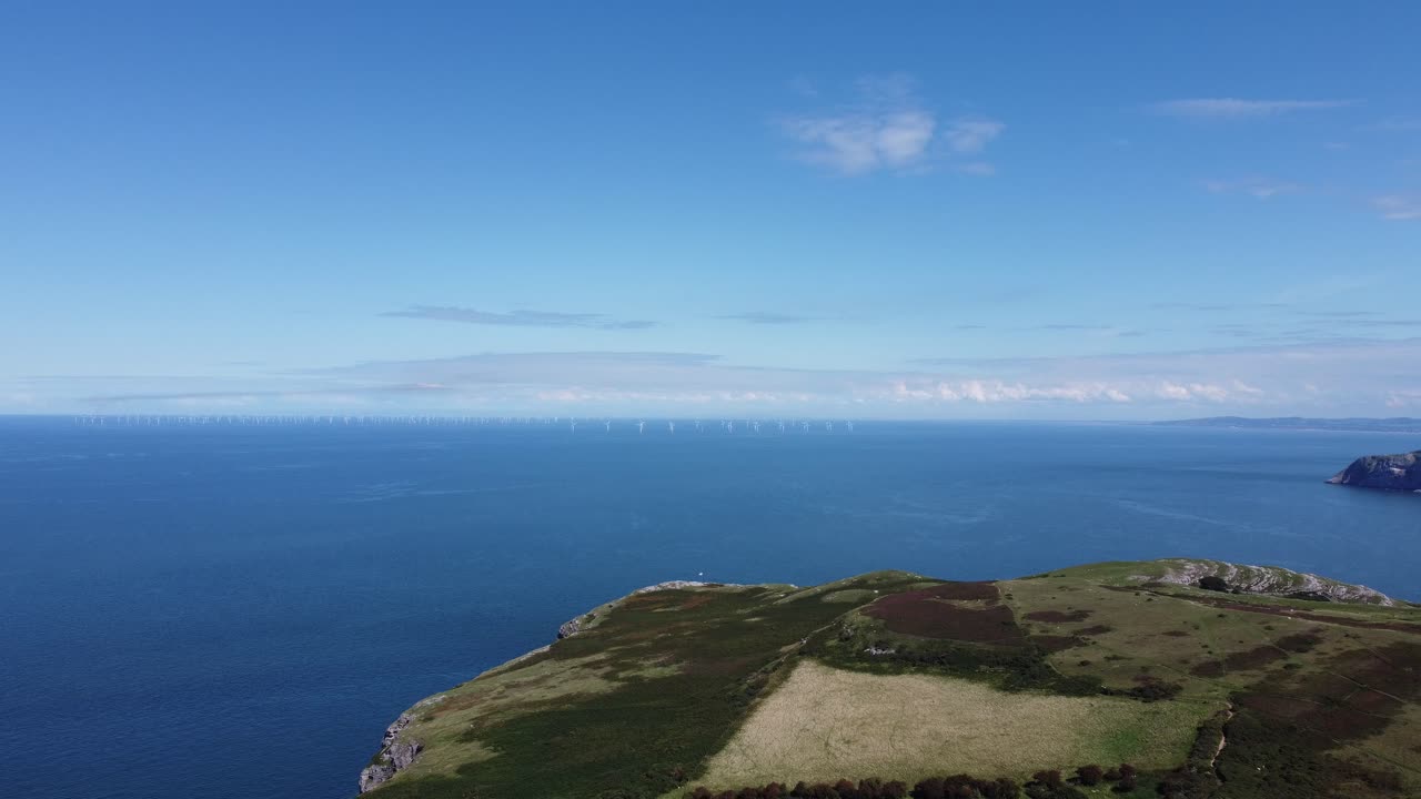 Static Cinematic 4K drone clip of the Gwynt y M&ocirc;r and Rhyl Flats offshore wind farms from the Great Orme, Wales, UK