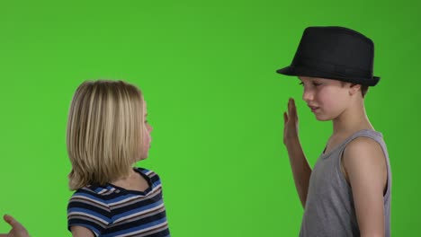 two kids giving high five to each other in front of greenscreen