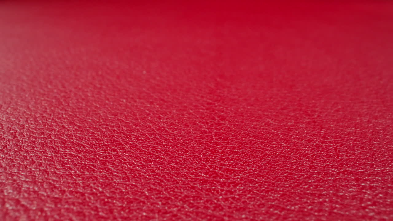 Texture of cow leather surface colored red as background
