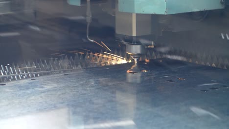 CNC-fiber-laser-cutting-machine-with-bright-sparks.-Metalworking-process