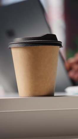 vertical video male freelancer drinking coffee and solving his daily assignments at home