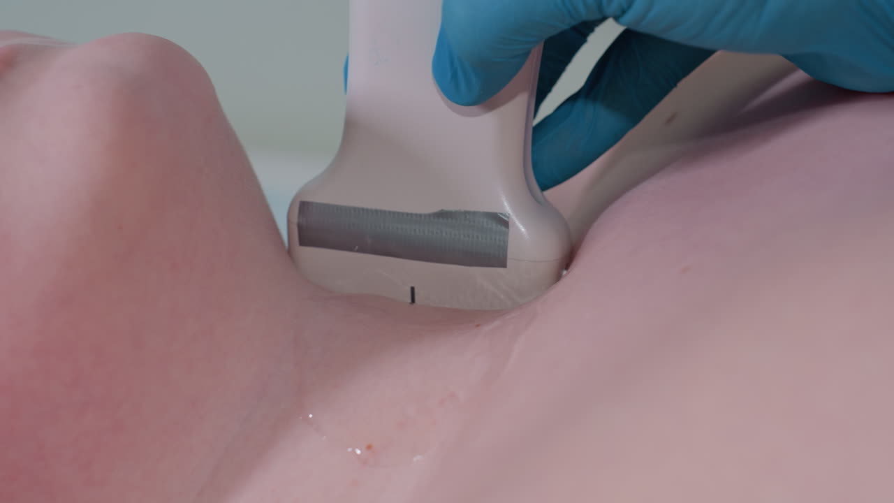 Close up of medical practitioner gently pressing ultrasound transducer with gel on patient neck during diagnostic examination, focusing on careful technique and precision in healthcare procedure