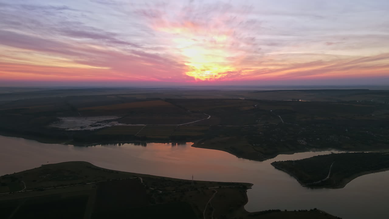 Aerial drone view of the Duruitoarea natural reservation at sunset in Moldova. River and village, hills and fields
