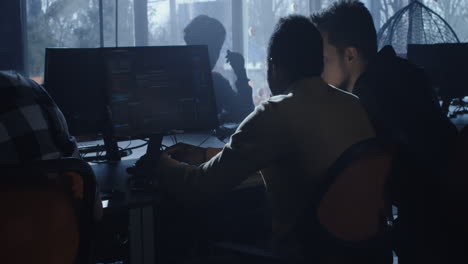 Team of programmers working together in a computer lab