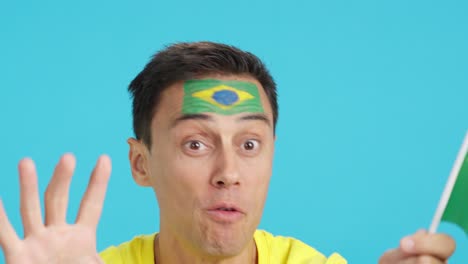close up of a man supporting brazilian team