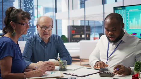 senior citizens consulting a broker to explore pension options