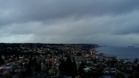 thick dark clouds over the commencement bay in tacoma, washington in stormy weather - aerial shot