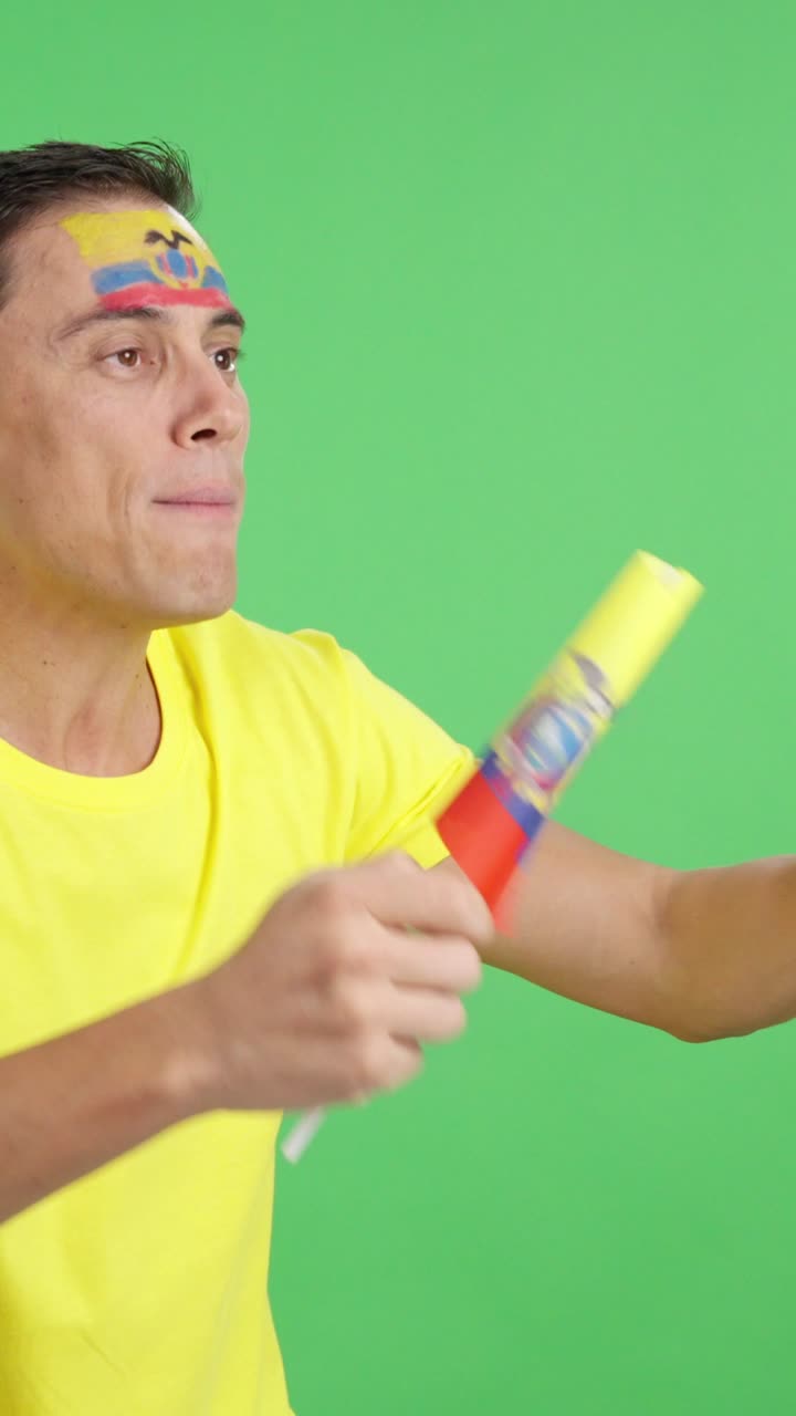 Man cheering for Ecuador waving a national flag looking away