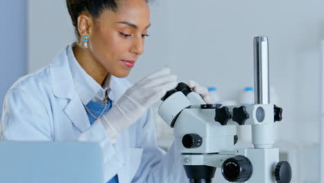 woman, laptop and forensic science with microscope