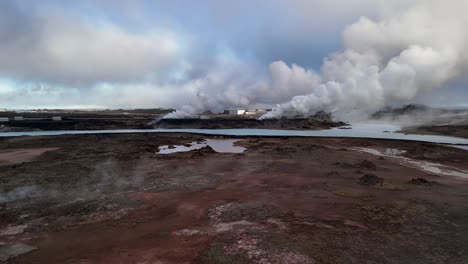 aerial view of geothermal power plant in icelandic landscape - drone shot