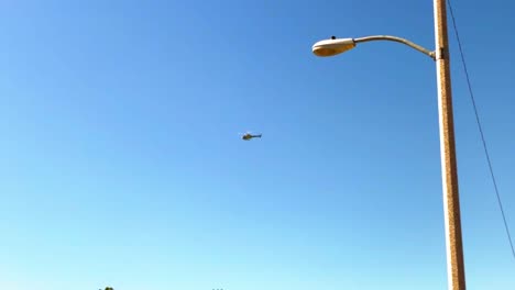 helicopter flying and circling over some houses in a southern california neighborhood.