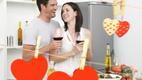 happy young couple enjoying wine in kitchen