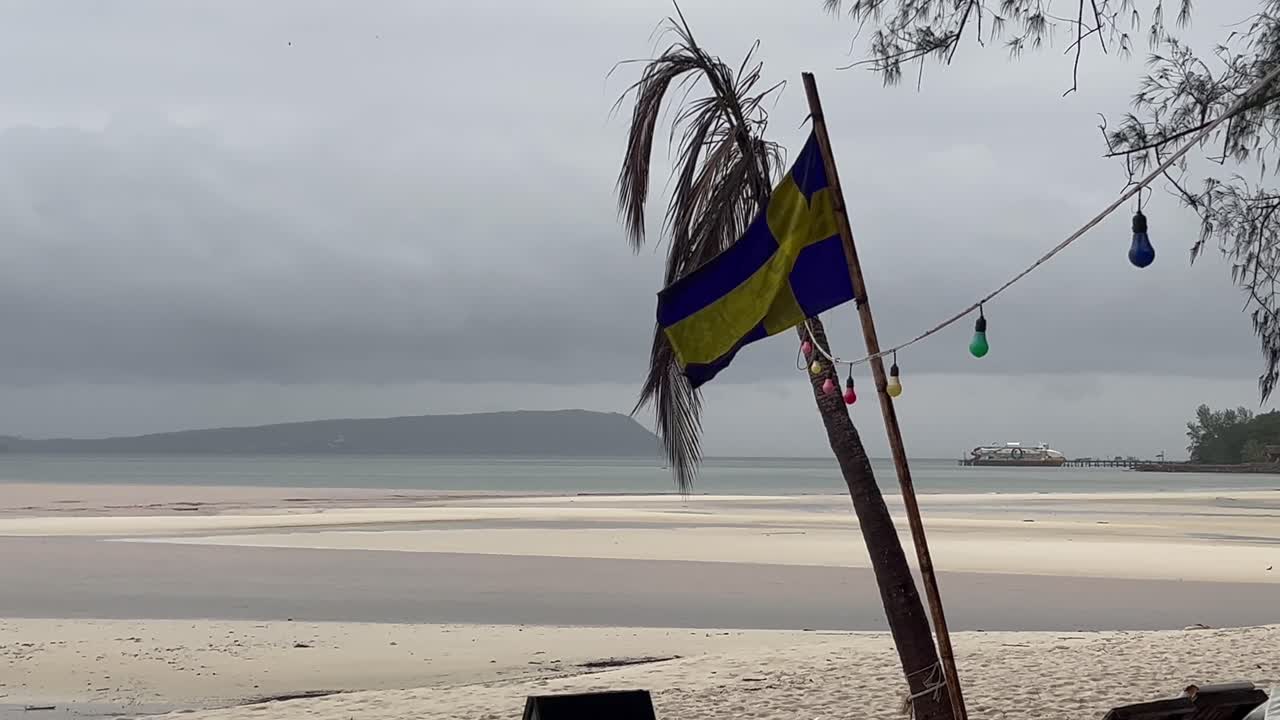 Swedish flag on a tropical beach