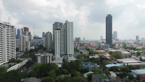 a view of tall buildings in phrom phong neighborhood in bangkok, thailand. aerial drone shot
