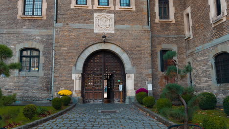 going by the paved road leading to the old brick mansion. beautiful pots with plans near the entrance to the castle.