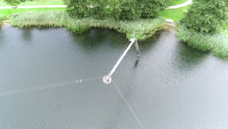 moving drone shot of pulling system at a wakeboarding lake