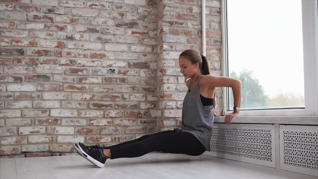 Woman Doing Push-ups Near a Window