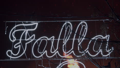 banner with the word falla on the street at night