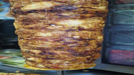 closeup of a shawarma on a rotisserie