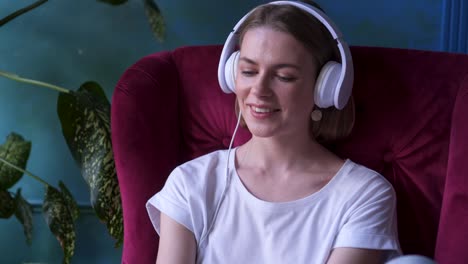 girl taking off headphones and looking at camera