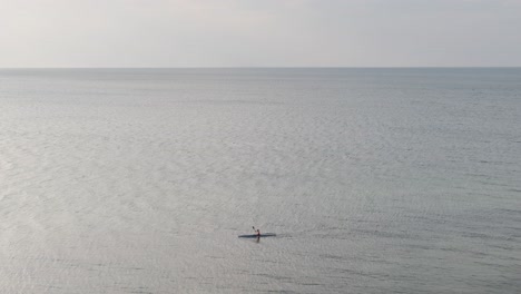 amplia vista del mar con una sola persona en canoa por el mar