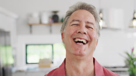 Portrait-of-happy-senior-caucasian-man-looking-at-camera-and-smiling,-slow-motion