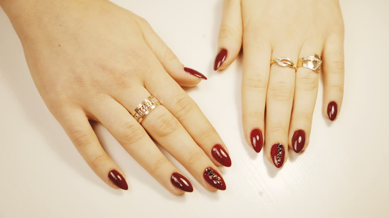 Red Nail Art with Gold Rings