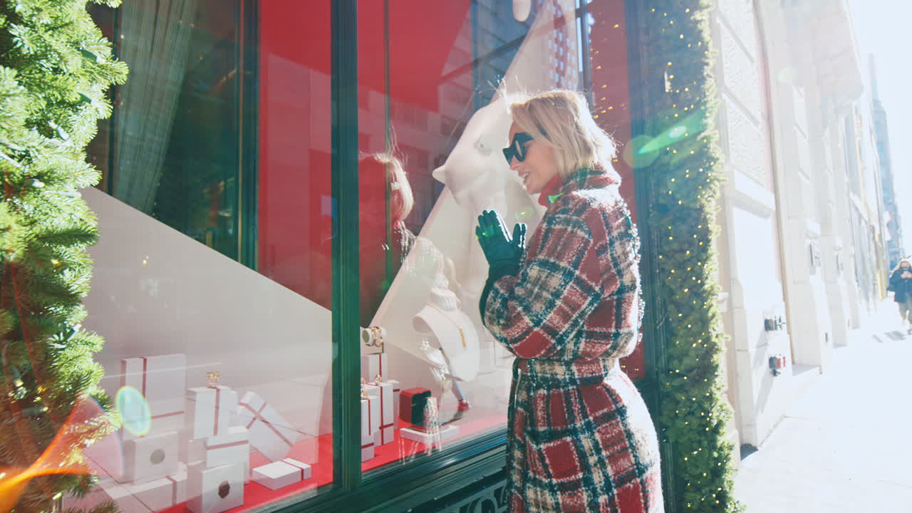 New York, USA, 25 October 2025: Woman in plaid coat looking at luxury jewelry window display. Close up of woman window shopping at jewelry boutique with rainbow lens flare in New York City