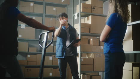 warehouse workers checking inventory and handling packages