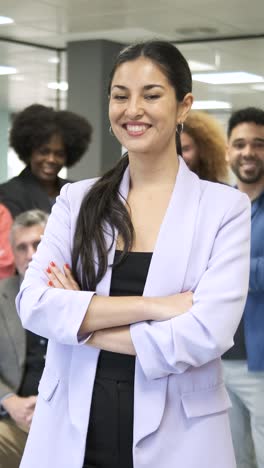 smiling female leader standing with crossed arms