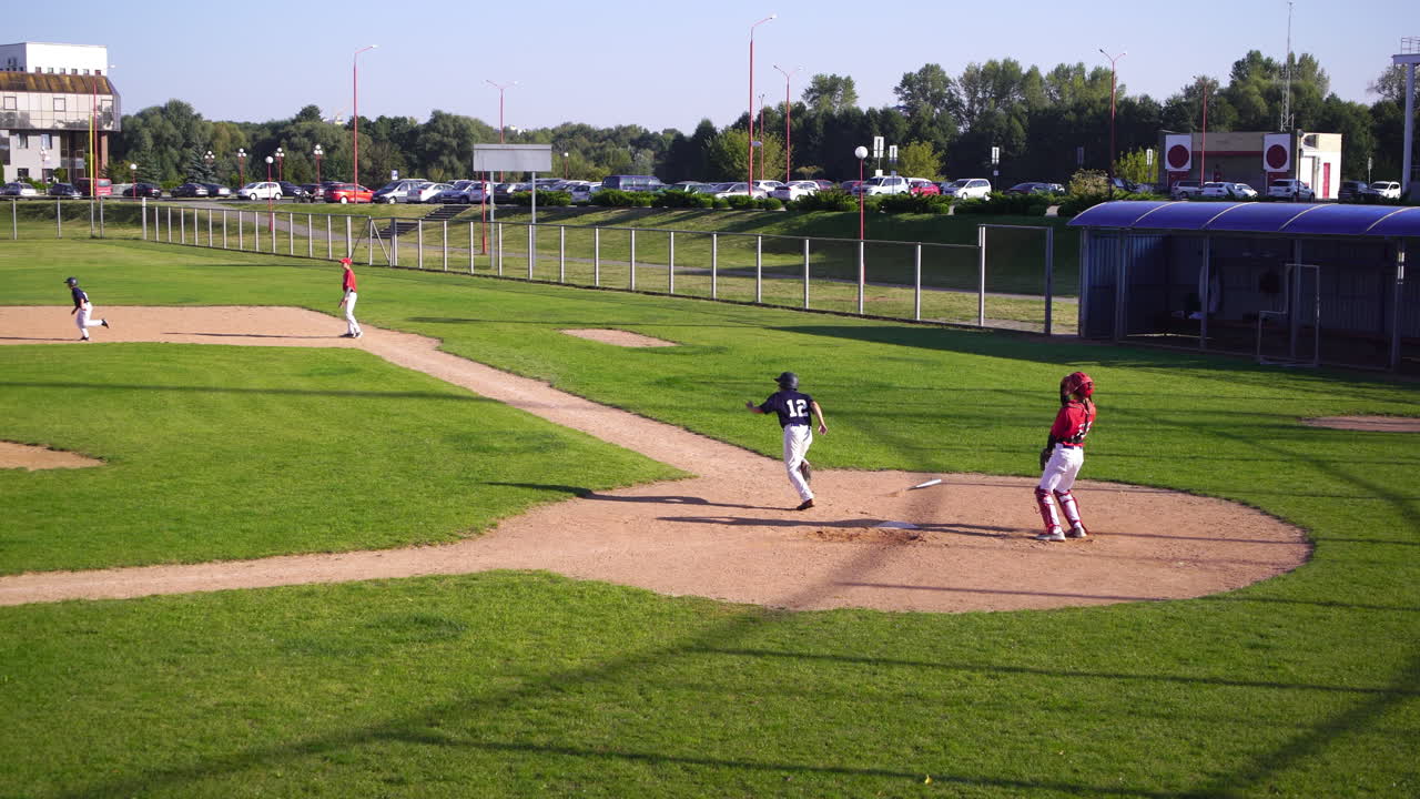 Wide shot of baseball game in progress on sunny day
