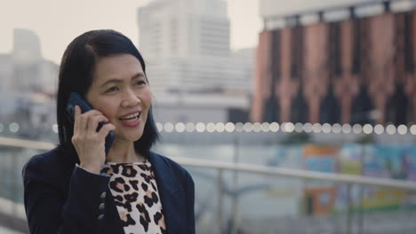 business woman on phone in city