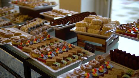 various desserts on plates back lit by daylight coming from a window