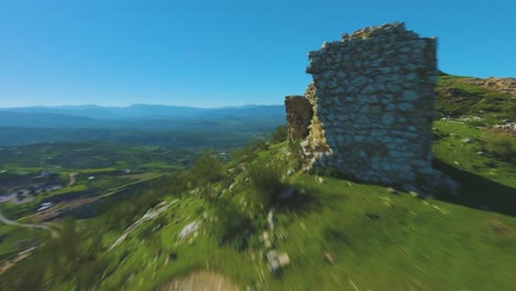 The-ruins-of-Castillo-de-la-Peña-shine-in-the-afternoon-sun-in-Jaén,-Spain-captured-by-a-drone-camera