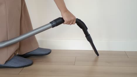 person vacuuming a room