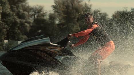 sportsman jumping on jet ski in slow motion. man riding jet ski on waves