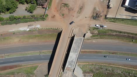 aerial view over a highway road bridge, with vehicles speeding by, in nairobi, kenya