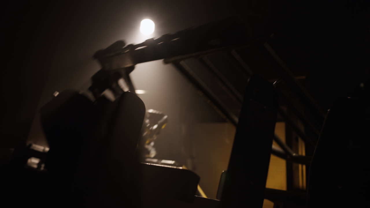 Dark Gym Equipment Under Spotlight