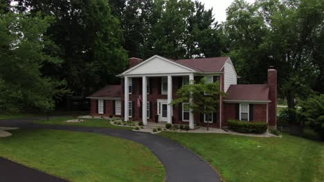 Aerial-Drone-Footage-of-a-Large-House-with-Columns-in-a-Luxury-Neighborhood