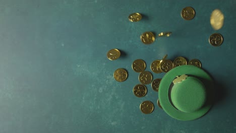 overhead studio shot of green leprechaun top hat and piles of gold coins to celebrate st patricks day 3