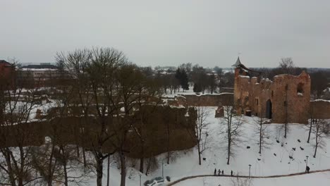 ruins of ancient livonian order's stone medieval castle latvia aerial drone top shot from above . restored castle capella at winter in dobele city. 4k resolution