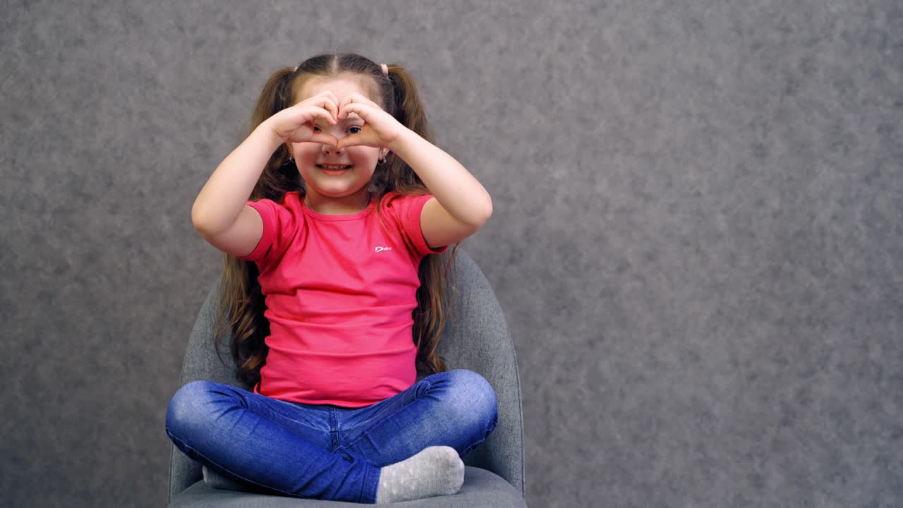 Portrait of happy child girl. Happy smiling child girl isolated on gray background