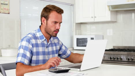 Man-calculating-with-calculator-and-drinking-coffee