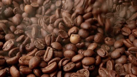 close up of seeds of coffee. fragrant coffee beans are roasted smoke comes from coffee beans.