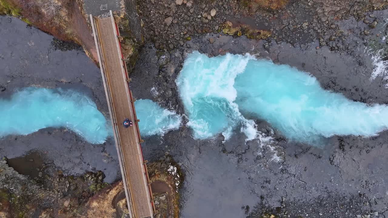 Highlight the natural beauty and majesty of the waterfall, turquoise color, and Icelandic landscape, Waterfall Bruararfoss