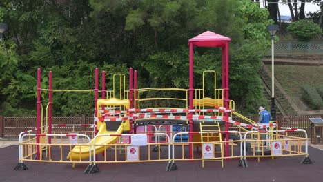 a closed slide play with tapes and barriers seen at a public playground due to the covid-19 coronavirus outbreak and restrictions in hong kong