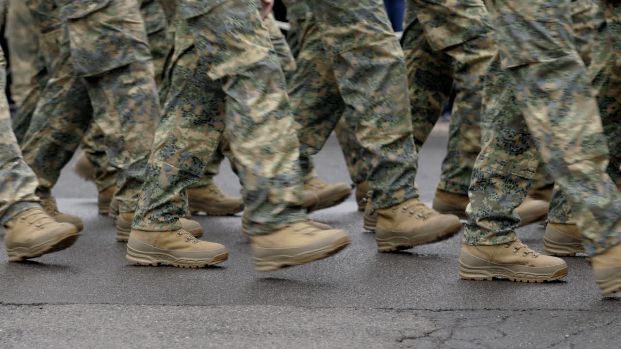 Military Personnel Marching in Camouflage Uniforms