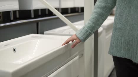 Woman-Is-Choosing-A-New-Ceramic-Sink-In-A-Store