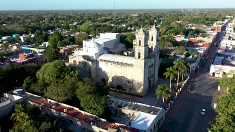 Aerial-orbit-to-the-right-showing-the-Cathedral-de-San-Gervasio-just-after-sunrise-in-Valladolid,-Yucatan,-Mexico